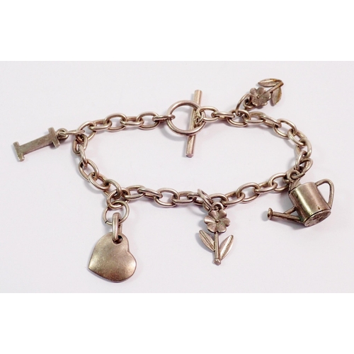 415 - A silver charm bracelet with watering can, heart and flower charms etc, 26g