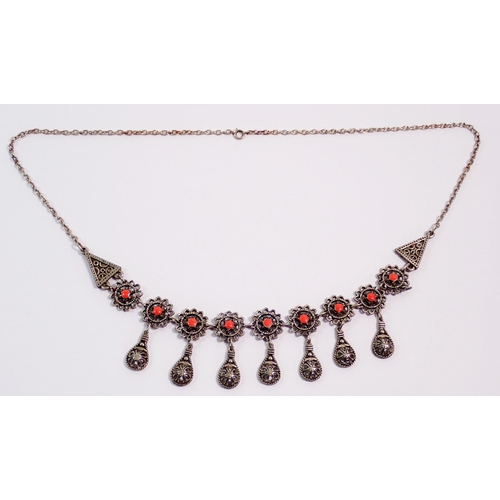 417 - An Indian white metal necklace set coral links and seven pendant drops