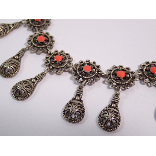 417 - An Indian white metal necklace set coral links and seven pendant drops