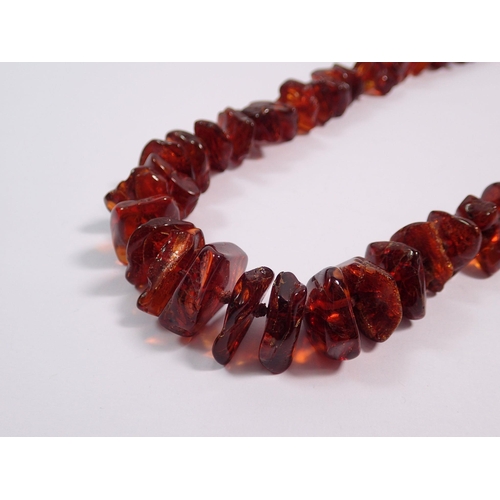 424 - A chip amber necklace, 62cm long