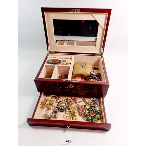 445 - A jewellery box with contents including earrings, brooches, bracelets etc