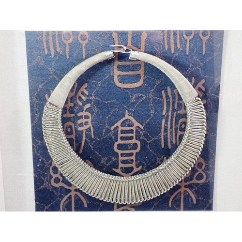 447 - An African tribal white metal collar necklace - framed, necklace 25cm diameter