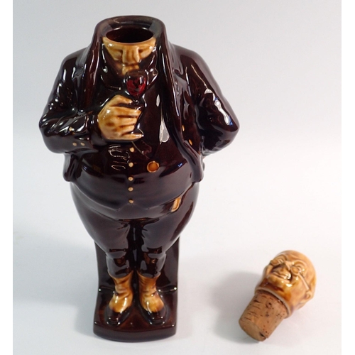 5 - A treacle glaze figurative flask in form of man with a wine glass, marked Foreign, 25cm tall