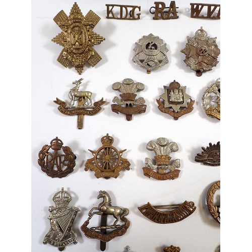 587 - A quantity of military cap badges