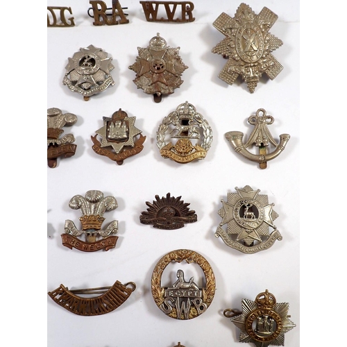 587 - A quantity of military cap badges