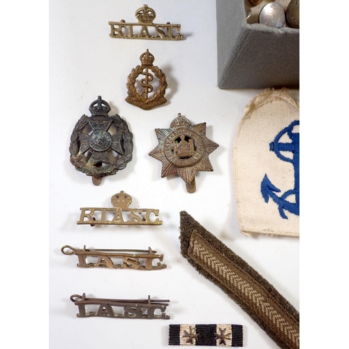 604 - A collection of military badges and buttons etc.