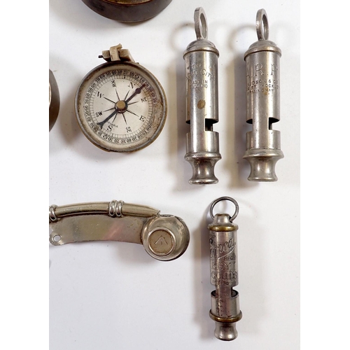 605 - A selection of military whistles, compasses etc.