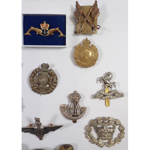 606 - A quantity of cap badges, buckles etc.