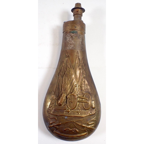 611 - A 19th century brass powder flask embossed war trophies