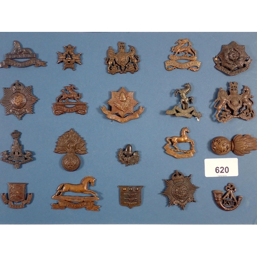 620 - A carded display of 20 Military officers service dress cap and collar badges, The Cheshire Regiment,... 