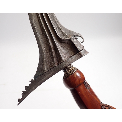 636 - An Indonesian Kris with etched blade, carved handle and brass and wood scabbard, total length 44.5cm