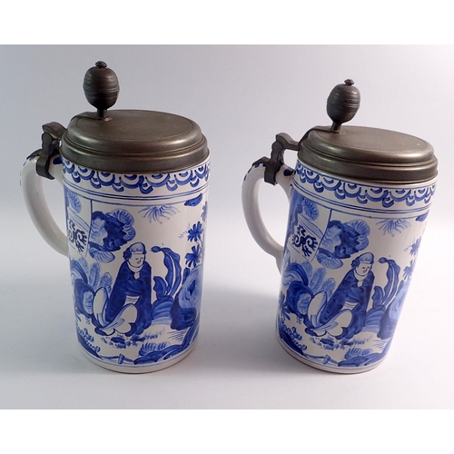 65 - A pair of large Delft style pewter topped tankards, 25cm tall