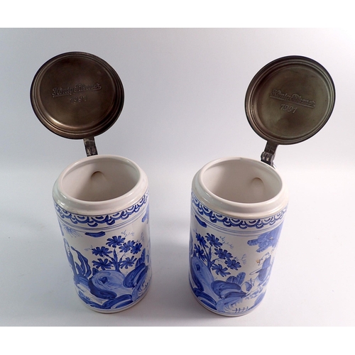 65 - A pair of large Delft style pewter topped tankards, 25cm tall