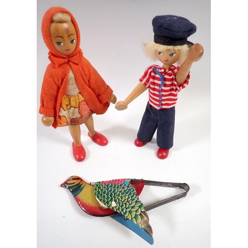 691 - Two vintage peg dolls and a tin plate 'flapping' bird toy