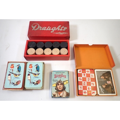 711 - A set of Biggles playing cards and two other set and a set of dominoes