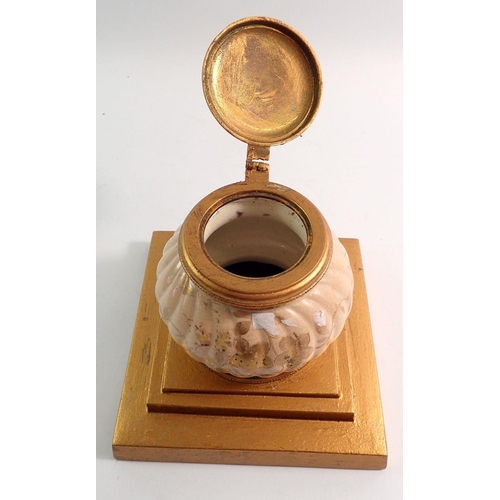 84 - A Victorian peach and gilt pottery circular inkwell mounted on plinth base, 15cm tall