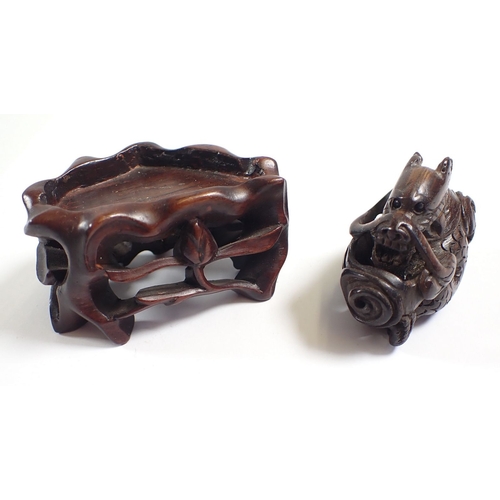 818 - A Japanese carved wood dragon netsuke and stand - dragon 5cm long