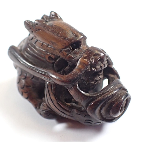 818 - A Japanese carved wood dragon netsuke and stand - dragon 5cm long