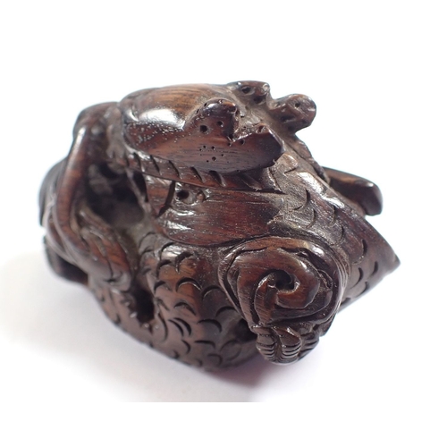 818 - A Japanese carved wood dragon netsuke and stand - dragon 5cm long