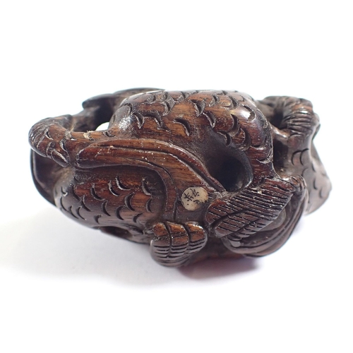 818 - A Japanese carved wood dragon netsuke and stand - dragon 5cm long