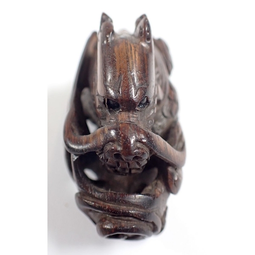 818 - A Japanese carved wood dragon netsuke and stand - dragon 5cm long