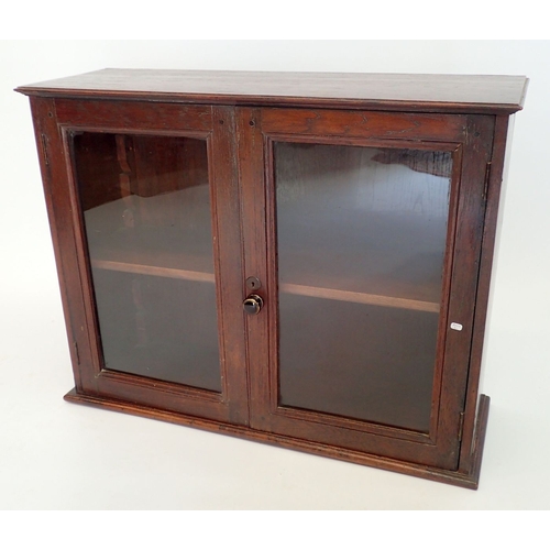 992 - An Edwardian mahogany small table top glazed cupboard, 79.5cm wide