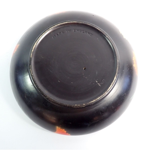 10 - A vintage black pottery bowl with central candle holder, 26cm diameter