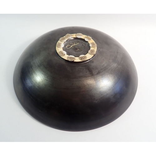 11 - A studio pottery black bowl painted red flower, 30cm