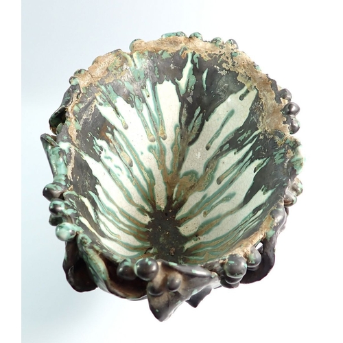 3 - A pottery woman's head with trailed green and black glazes, 26cm