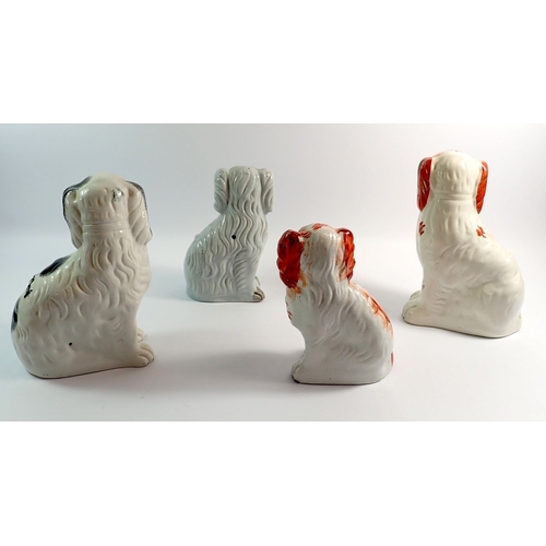 30 - Four various Victorian Staffordshire dogs, largest 26cm
