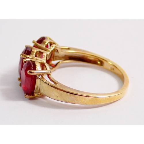 277 - A 9ct gold three stone ruby ring, 4g, size K to L