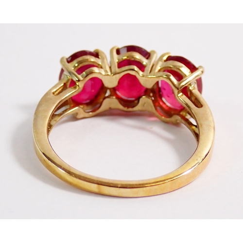 277 - A 9ct gold three stone ruby ring, 4g, size K to L