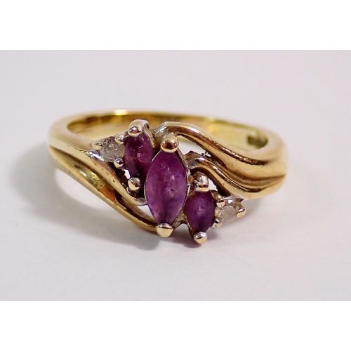 296 - A 9 carat gold crossover ring set three amethysts and two chip diamonds, 3g, size J to K