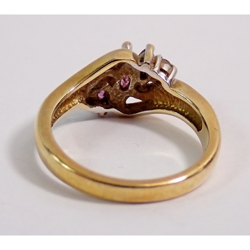 296 - A 9 carat gold crossover ring set three amethysts and two chip diamonds, 3g, size J to K