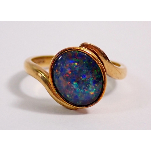 297 - A 9ct gold ring crossover set opal doublet, 3g, size L
