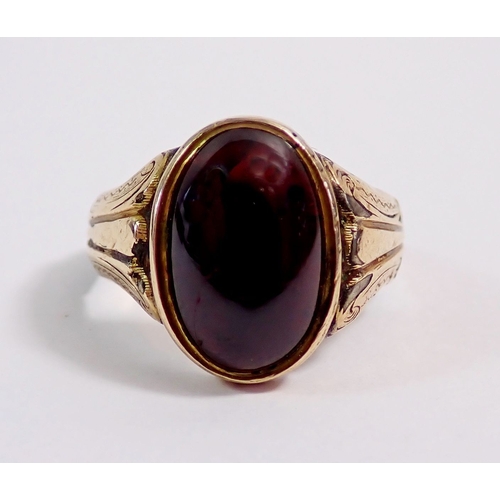 299 - A Victorian yellow metal ring set cabochon cut garnet, size N, 3.5g