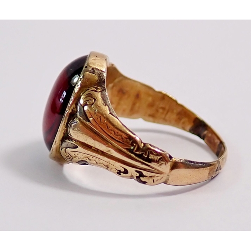 299 - A Victorian yellow metal ring set cabochon cut garnet, size N, 3.5g