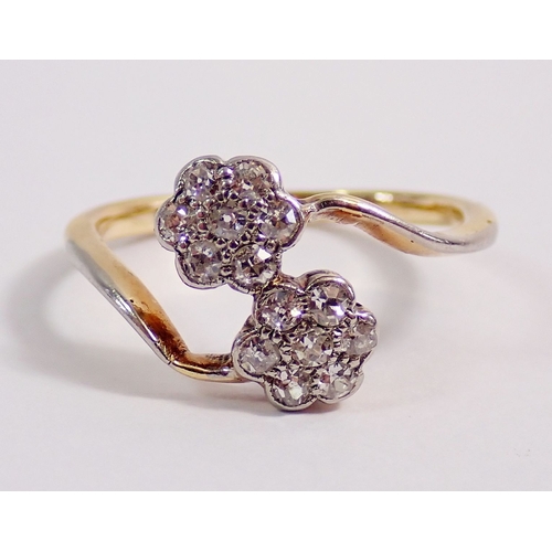 307 - An Edwardian 9 carat gold ring crossover set two flower form diamond clusters, size K-L, 2.1g, hallm... 
