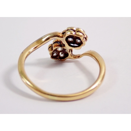 307 - An Edwardian 9 carat gold ring crossover set two flower form diamond clusters, size K-L, 2.1g, hallm... 