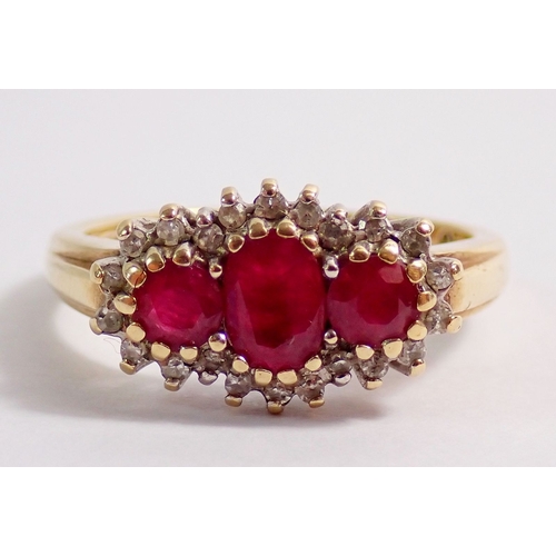 313 - A 9ct gold ring set three rubies in diamond surround, 3.4g, size N