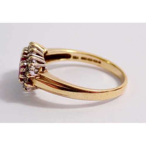 313 - A 9ct gold ring set three rubies in diamond surround, 3.4g, size N