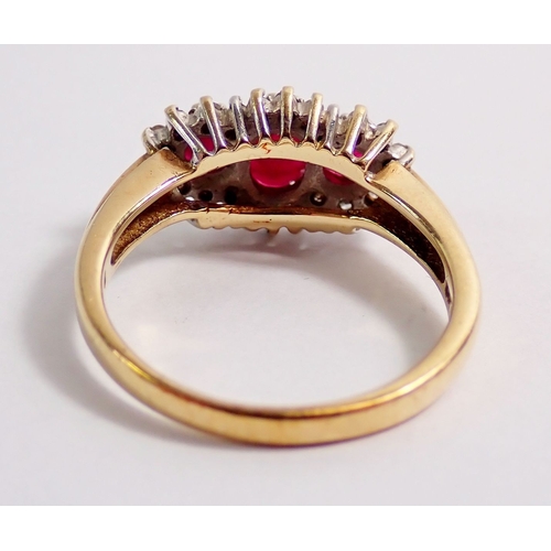 313 - A 9ct gold ring set three rubies in diamond surround, 3.4g, size N