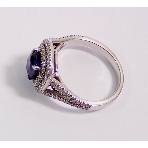 315 - A platinum sapphire and diamond cluster ring set cushion cut sapphire (approx 1.25 cts) within doubl... 