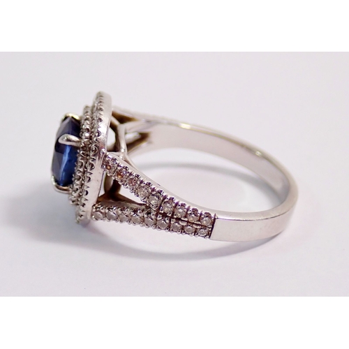 315 - A platinum sapphire and diamond cluster ring set cushion cut sapphire (approx 1.25 cts) within doubl... 