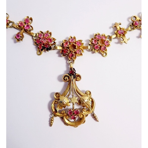 321 - A Victorian gilt metal necklace in the Aesthetic style with pendant drop on ornate chain, all set pi... 