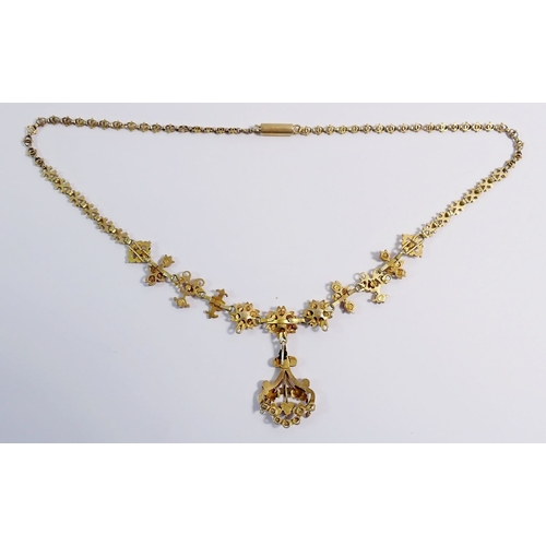 321 - A Victorian gilt metal necklace in the Aesthetic style with pendant drop on ornate chain, all set pi... 