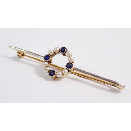 326 - An Edwardian 15 carat gold and platinum pearl and sapphire circular set bar brooch, 4g, 6cm