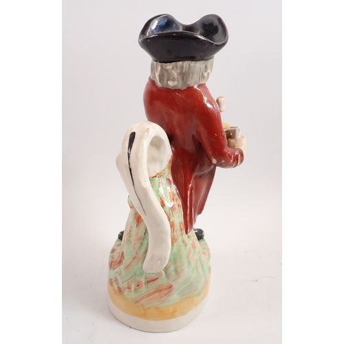 33 - A Staffordshire toby jug with jug of ale 'Hearty Fellow' 28cm