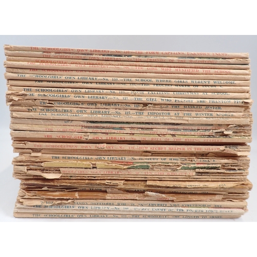 604 - A group of childrens books including Ladybird books, The Schoolgirls Own Library magazines etc.
