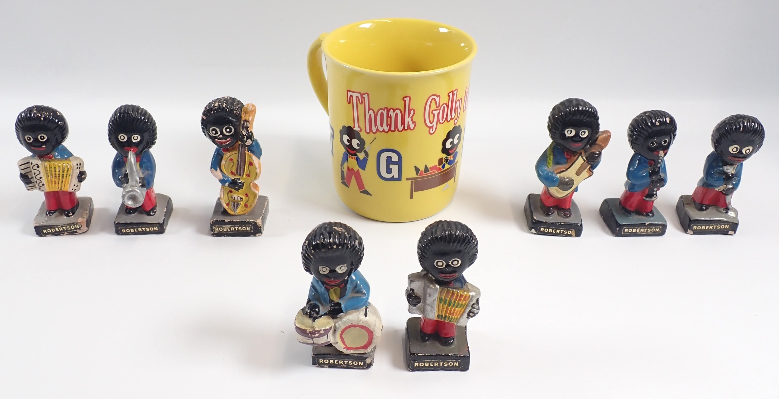 A set of eight plaster Robinson's Jam musician figures and a mug